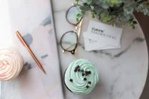 cupcakes and decorations surrounded by CAYK branding items.