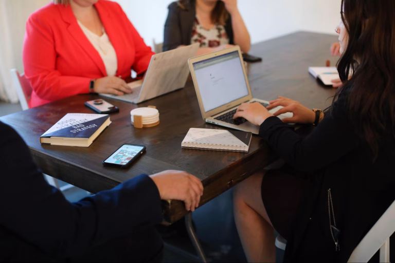 An employer, along with a web developer, is discussing how to create a social media campaign that drives summer sales.