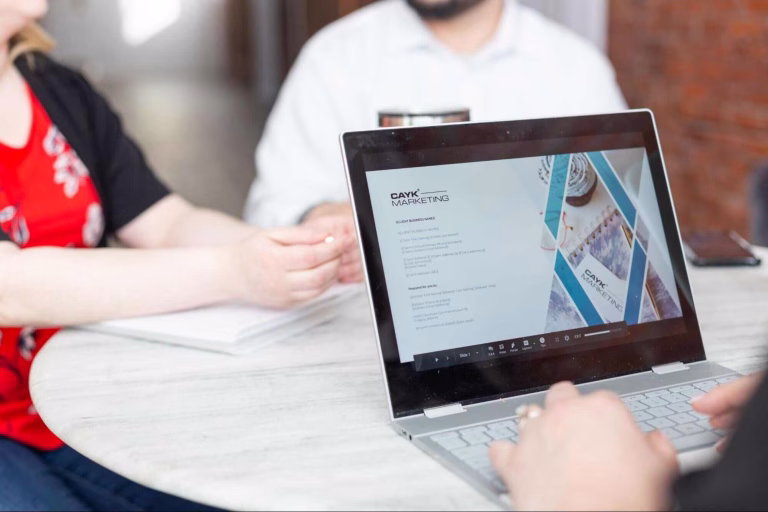 Close-up of a marketing specialist analyzing campaign data on a laptop, illustrating a key step in how to choose a digital marketing agency based on technical expertise and measurable results.