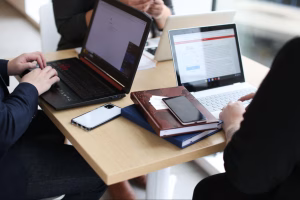 Team discussing digital strategy, blogging ideas, and content marketing strategy on laptops during a planning meeting.