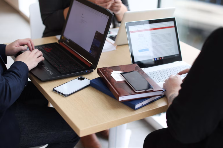 Team discussing digital strategy, blogging ideas, and content marketing strategy on laptops during a planning meeting.