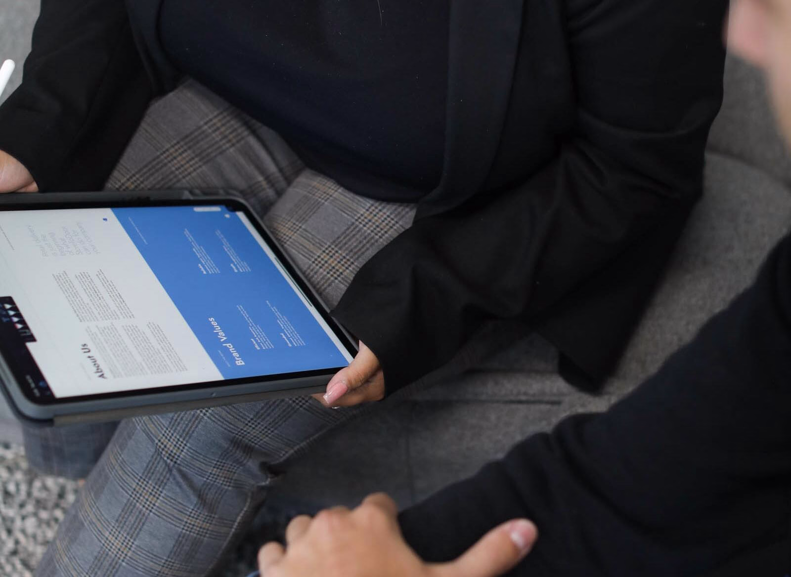 Marketing professional reviewing website content on a tablet, illustrating what search intent means and how users find relevant online information.